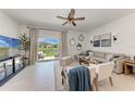 Bright living room with stylish furniture, neutral decor, and sliding glass doors to an outdoor patio at 5711 Archipelago St, Nokomis, FL 34275