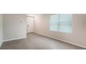 The spacious living room has large windows and tile flooring, providing ample natural light at 5905 Silver Sage Way, Sarasota, FL 34232
