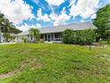 Charming single-story home with a well-maintained lawn, screened lanai, and mature landscaping at 601 136Th St E Ct, Bradenton, FL 34212