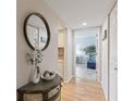 Hallway with mirror and views to the kitchen and living room at 6265 Midnight Pass Rd # 205, Sarasota, FL 34242