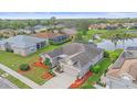 Aerial view of home with lush backyard, complemented by nearby pond at 6266 Buckingham St, Sarasota, FL 34238