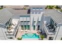 An aerial view showcasing a private pool, patio, and balcony in the home's backyard at 6317 Turtle Grass Dr, Bradenton, FL 34210