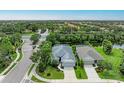 Aerial view of a charming home featuring landscaped grounds near a pond and neighborhood amenities at 6516 Palm Leaf Ct, Sarasota, FL 34243