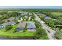Aerial view of the home showing the proximity to a pond and the lovely neighborhood at 6516 Palm Leaf Ct, Sarasota, FL 34243