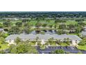 Aerial view of condo complex overlooking golf course, lake, and lush landscaping at 7110 Fairway Bend Ln # 181, Sarasota, FL 34243
