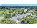 Scenic aerial view showcasing the condo's proximity to a golf course and lake at 7110 Fairway Bend Ln # 181, Sarasota, FL 34243