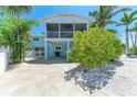 Home featuring a spacious screened patio with a fan, providing the perfect area to relax at 733 Holly Rd, Anna Maria, FL 34216