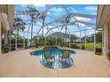 Relaxing screened-in pool area with comfortable seating and view of the lush backyard at 7615 Charleston St, Bradenton, FL 34201