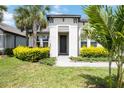 Close-up of the home's entrance, highlighting the door and manicured landscaping at 918 Fernleaf Run, Bradenton, FL 34212
