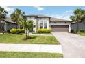 Charming single-story home with a brick-paver driveway and mature, lush landscaping at 918 Fernleaf Run, Bradenton, FL 34212