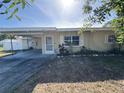 Charming home showcasing a well-maintained exterior with a cozy carport and manicured landscaping at 1224 38Th W St, Bradenton, FL 34205