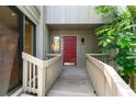Home's charming entryway featuring a red front door and walkway at 1347 Landings Dr # 6, Sarasota, FL 34231
