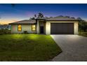 Charming one-story home featuring a two-car garage, neutral color palette, and well-manicured lawn with paver driveway at 1532 Maricopa Rd, North Port, FL 34287
