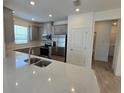 Modern kitchen with stainless steel appliances, granite countertops, and ample cabinet space at 16048 Ivy Ridge Ct, Port Charlotte, FL 33953
