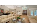 Bright living room featuring neutral walls, hardwood floors, stylish furnishings, and a view of the grand entrance at 1627 Peregrine Point Ct, Sarasota, FL 34231