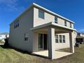 This home has a covered patio and sliding glass door with a manicured lawn at 17637 Cantarina Cv, Bradenton, FL 34211