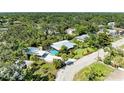 This aerial view features the neighborhood, pool, lush surroundings and property location at 2321 Milford Cir, Sarasota, FL 34239