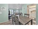 Open-concept floor plan with a dining area featuring a gray wooden table with seating for six at 2901 26Th W St # 204, Bradenton, FL 34205