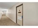 Hallway leading to a condo with a decorated door at 2901 26Th W St # 204, Bradenton, FL 34205