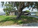 Single-story home with shade trees, a covered driveway, and landscaped front yard at 3307 Miami Pl, Bradenton, FL 34207