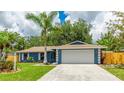 Lovely single-story home with lush green lawn and well-maintained landscaping at 3525 Riviera Dr, Sarasota, FL 34232