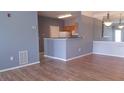 Open-concept living room boasts hardwood floors and connects seamlessly to the kitchen area at 4802 51St W St # 1313, Bradenton, FL 34210