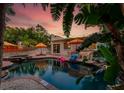 Tropical backyard with a luxurious pool, spa, and patio area, perfect for outdoor entertaining at 522 31St W St, Bradenton, FL 34205