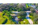 Breathtaking aerial view of a Florida home showcasing mature landscaping, a pond with fountain, and surrounding neighborhood at 5311 36Th E Ave, Palmetto, FL 34221