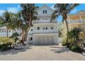 Three-story house with balconies, complemented by lush tropical landscaping at 538 Canal Rd, Sarasota, FL 34242