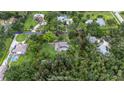 Aerial view showing the home with a large lot surrounded by mature trees offering privacy at 5430 Richardson Rd, Sarasota, FL 34232
