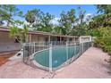 Backyard features a private pool with a safety fence, offering a relaxing outdoor space at 5430 Richardson Rd, Sarasota, FL 34232