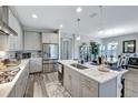 Gourmet kitchen features a large center island, stainless steel appliances, quartz countertops, and shaker cabinets at 6219 Golden Nettle Dr, Apollo Beach, FL 33572