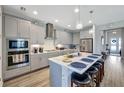 This spacious kitchen features a center island, bar seating, pendant lighting, stainless appliances, and shaker cabinets at 6219 Golden Nettle Dr, Apollo Beach, FL 33572