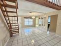 Spacious living room with tiled flooring, bright natural light, and access to the dining room at 6305 Bikini Rd, Sarasota, FL 34241
