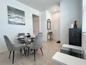 Elegant dining area with a glass table, plush chairs, and a calming artwork on the wall at 6358 Fairmont Ln, Palmetto, FL 34221
