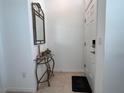 Inviting entryway with a decorative mirror above a table, and a door with keyless entry at 6358 Fairmont Ln, Palmetto, FL 34221