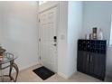 Inviting entryway with sleek tile flooring and a stylish storage unit for drinks and decor at 6358 Fairmont Ln, Palmetto, FL 34221