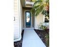 Close-up of front door with a decorative glass panel and neutral-colored exterior siding at 7750 Ridgelake Cir, Bradenton, FL 34203