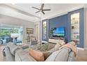 Bright living room featuring elegant furnishings, a contemporary ceiling fan and recessed lighting at 7983 Sandstar Way, Sarasota, FL 34240