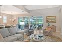 Inviting living area that offers views of the beautiful outdoor pool and patio area at 7983 Sandstar Way, Sarasota, FL 34240