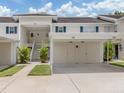 Charming condo with covered parking, stairway access, and vibrant landscaping enhance curb appeal at 821 Montrose Dr # 103, Venice, FL 34293