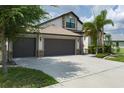 Charming single-Gathering home with lush landscaping, a 3-car garage and stone facade at 9236 Raes Creek Pl, Palmetto, FL 34221