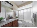 Well-lit bathroom with granite countertop, ample cabinet space, and shower-tub combination at 1299 Tripoli, North Port, FL 34286