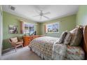 Cozy bedroom features two windows, a ceiling fan, and traditional-style furniture, creating a tranquil retreat at 1299 Tripoli, North Port, FL 34286