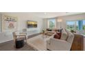 Sun-filled living area is decorated with modern furniture, a large screen TV and a view to the yard at 13113 Bayberry Way, Parrish, FL 34219