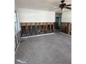 A large living room awaits renovation and finishing, showing interior framing at 13434 1St St E, Madeira Beach, FL 33708