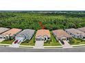 An aerial view of the home in a community surrounded by lush greenery at 13513 Deep Blue Pl, Bradenton, FL 34211