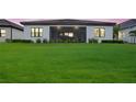 Lush backyard featuring a spacious lawn and screened in porch, great for entertaining at 13513 Deep Blue Pl, Bradenton, FL 34211
