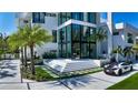Contemporary home with manicured lawn, stylish driveway, and a modern glass-enclosed entrance at 1610 N Lodge Dr, Sarasota, FL 34239