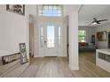Bright foyer with high ceilings, tile floors, and a view of the living room at 16231 Tradewind Ter, Bradenton, FL 34211